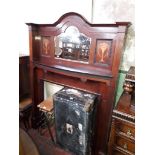 An Edwardian inlaid mahogany and mirror back fire surround.