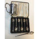 A boxed set of 6 silver spoons, a silver handled button hook and a silver "Graduation Day" mug.