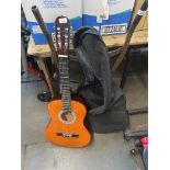 A Lauren acoustic guitar with soft case.