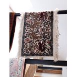 A Persian style carpet decorated with animals, 120cm x 50cm (approx),