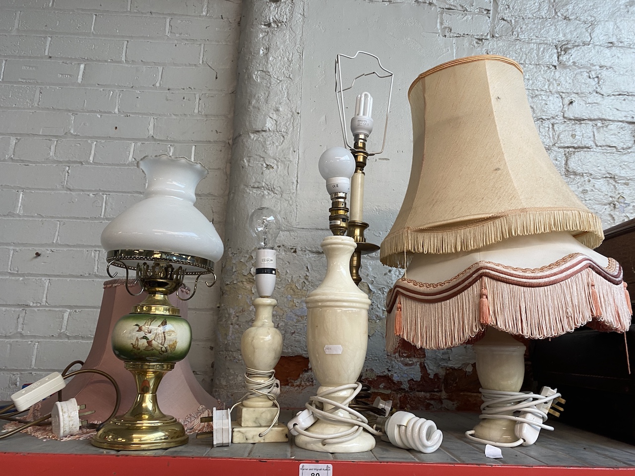 A collection of lamps to include onyx, brass and pottery.