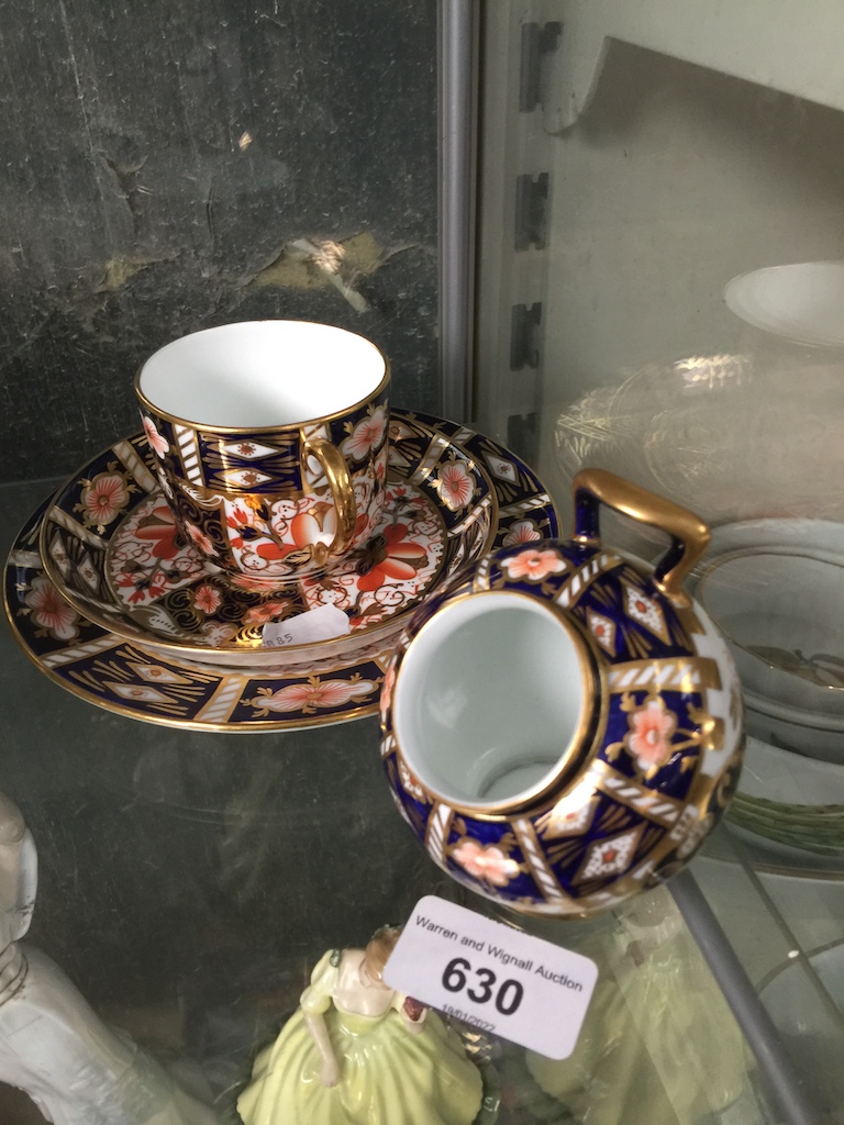 A Royal Crown Derby coffee cup, saucer and side plate in Imari design, along with a small salt pig