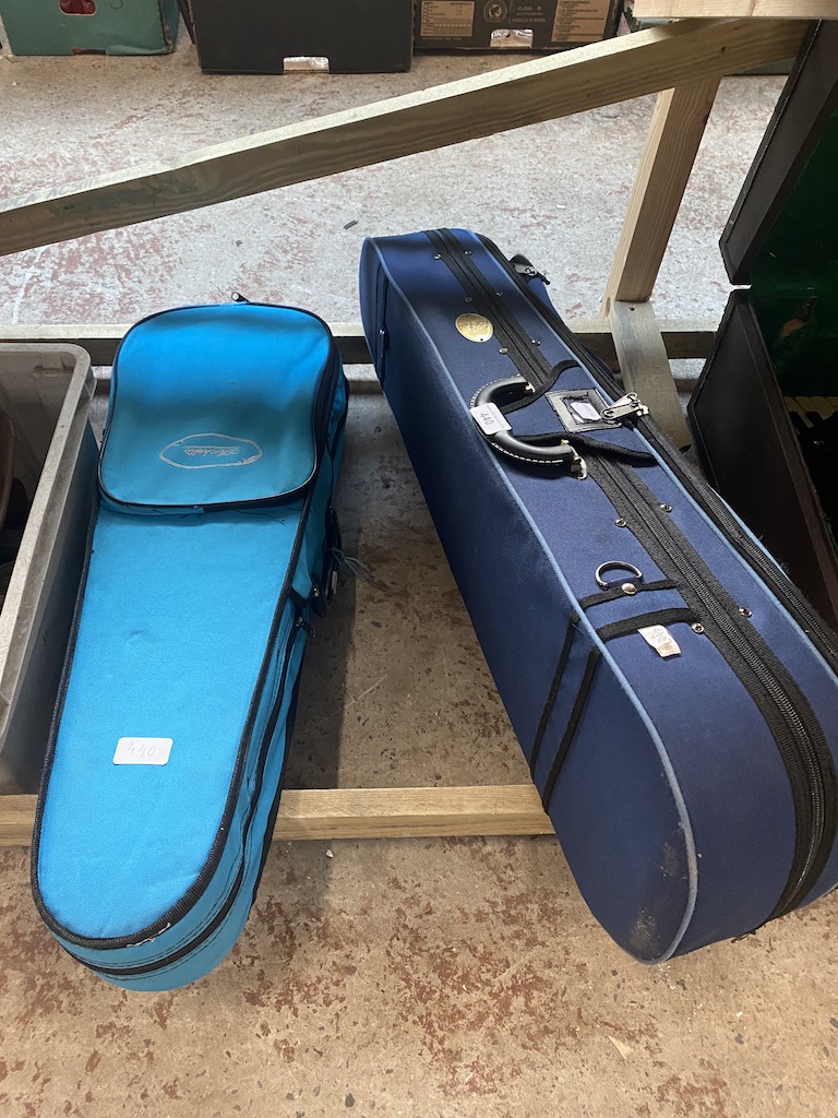 Two student violins with cases.