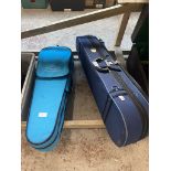 Two student violins with cases.