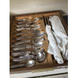 A tray of community plated cutlery.