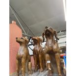 3 wooden dog statues