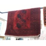 A vintage Eastern hand knotted wool carpet, red ground 190cm x 116cm (approx)