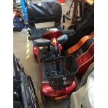 A mobility scooter with key and charger - in working condition.