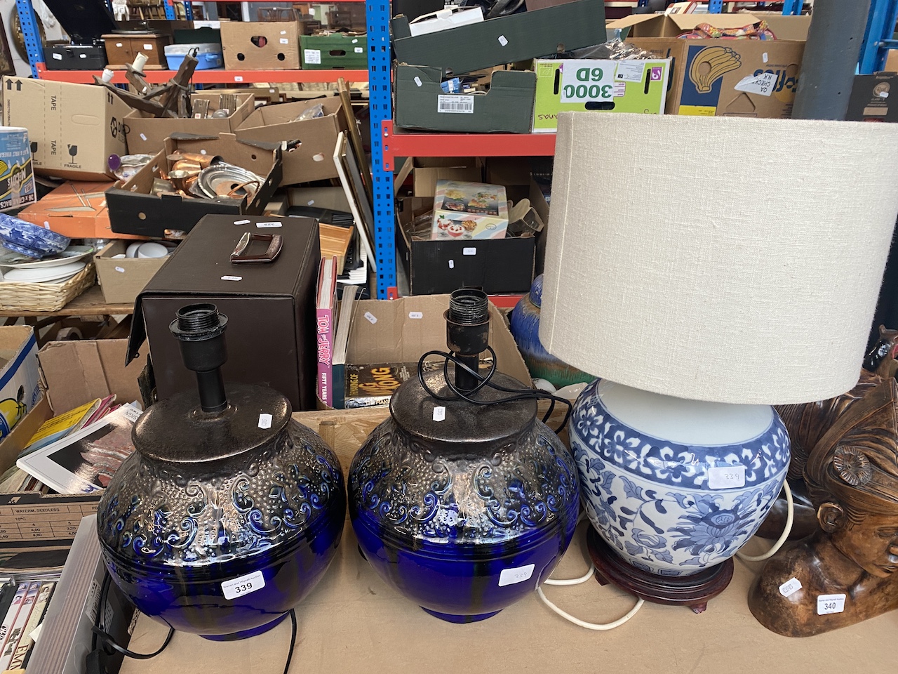 A pair of large blue lamps and an Oriental style pottery lamp.