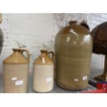 A large stoneware flagon and 2 small ones.