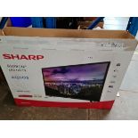 A 32" Sharp TV with remote