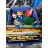 A mixed box containing Lego pieces, a bundle of annuals, and two Snoopy figures