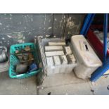 A toilet cistern, glass blocks and a box of bell weights, shoe last, torch, etc.