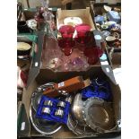 2 boxes containing plated ware, and glassware including tall decanter, together with 5 cranberry