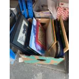 A box of pictures and enameled metal signs.