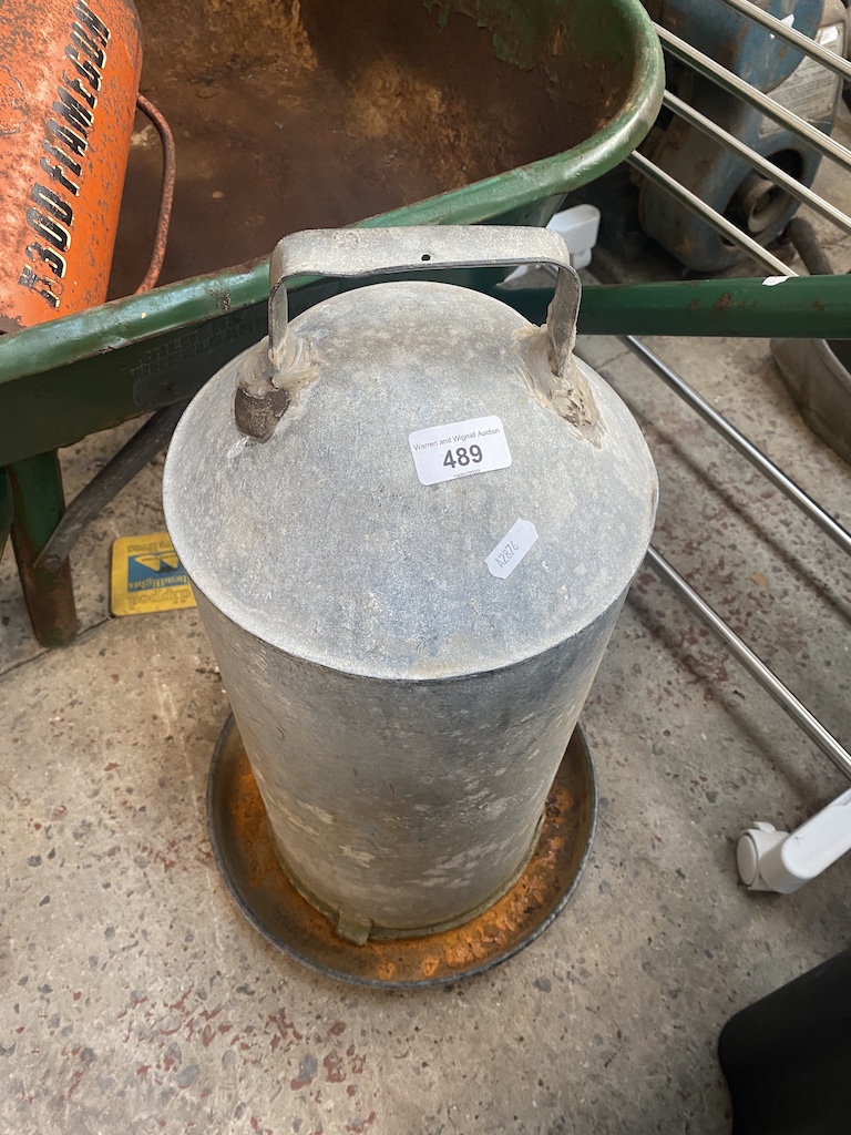 A galvanised poultry feeder