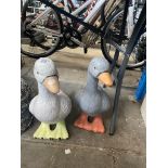 Two painted concrete duck figures