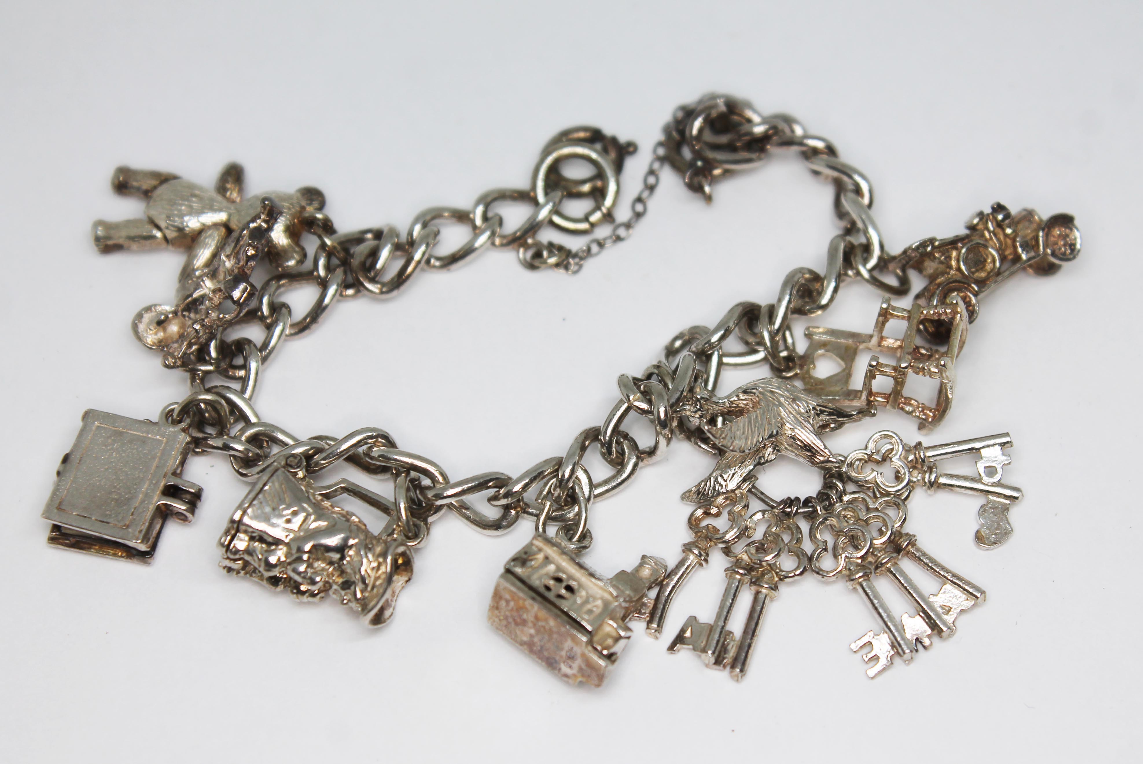 A charm bracelet marked 'Sterling', length 18cm.