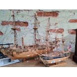 Two wooden model masted ships.