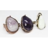 Three Art Nouveau style cabochon rings, two set with fluorite and the other a pale cream stone,