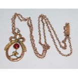 A yellow metal pendant set with red paste on chain marked '9c', gross wt. 3.26g.