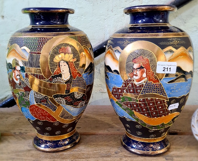 A pair of hand painted Japanese vases.