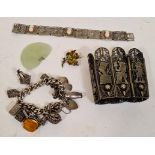 A antique silver bracelet with various charms, some marked silver, a German silver bracelet with