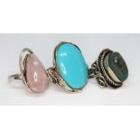 Three Art Nouveau style cahochon rings comprising one set with rose quartz and another reconstituted