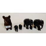 Pair of ebonised wood elephants with 2 smaller ones and a inkwell carved wood owl with glass eyes.