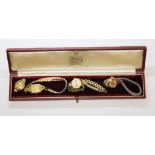 A Garrard & Co watch box containing four gold palted ladies wristwatches.