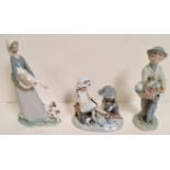 Three Lladro figures: Girl carrying goose, with puppy jumping up; Boy carrying fruit and veg
