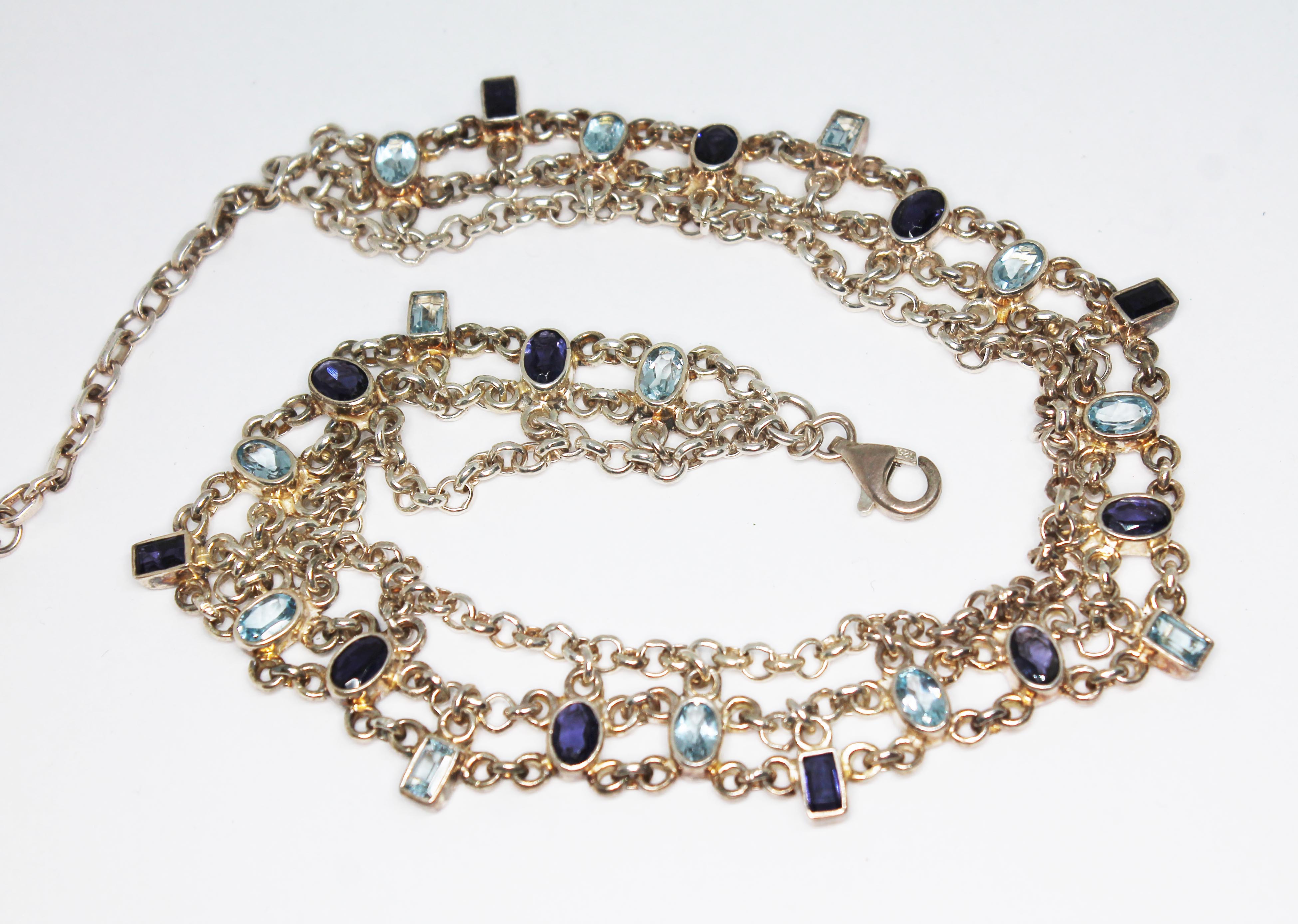 A choker necklace set with iolite and topaz, marked '925', length 28cm to 36cm.