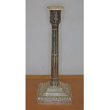 A Victorian silver candlestick of Gothic column form with acanthus capitol and stepped base, William