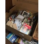 A box of football cards and photographs.