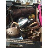 A box of shoe trees and crown green bowls.