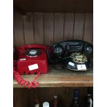 A retro style wall mounting red telephone and another.