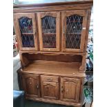 A dresser with leaded glass doors