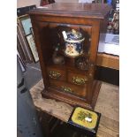 An antique smoker's cabinet and an ebonised wood box.