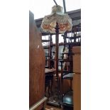 An early 20th century oak standard lamp.