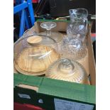 2 glass and wood cheeseboards, a cakestand, glass pitcher, small glass mug and a glass bowl.