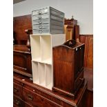 An oak magazine rack and two white shelving units and a 5 drawer metal organizer