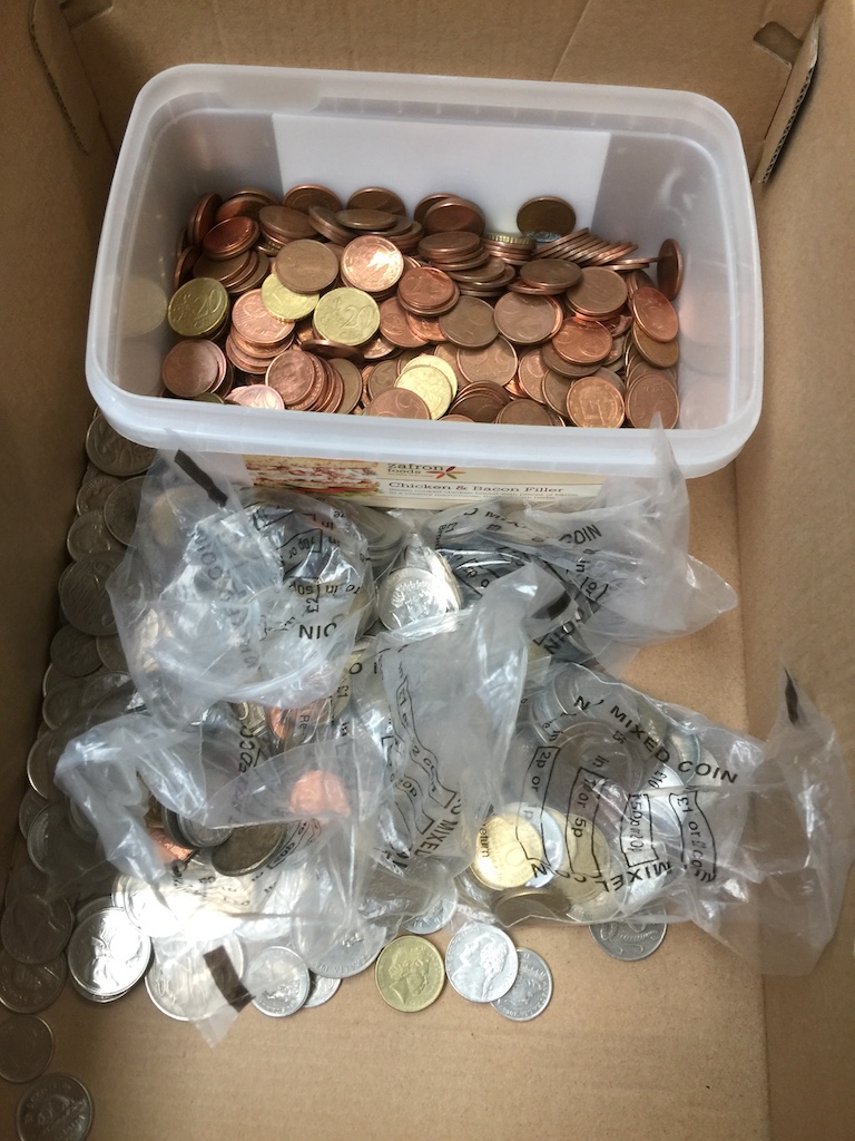 A box of coins, usable euros, USA dollars,, Canada dollars and Australian dollars