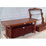 A retro teak coffee table and a wall hanging shelving unit.