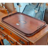 An Edwardian inlaid mahogany tray with shell detail.