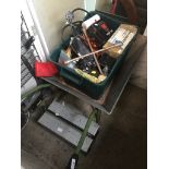 A wheelbarrow, a box of tools and other misc items and a metal toolbox with tools.
