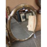 A modern gilt framed oval mirror appx 90cm x 67cm