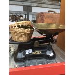 A set of vintage weighing scales with weights and 2 brass trays.