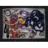 A tray of assorted jewellery including amethyst beads, coral, lapis lazuli etc.