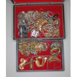 A jewellery box containing various vintage costume jewellery.