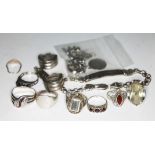 A white metal jewellery box containing various silver rings, bracelets, etc.